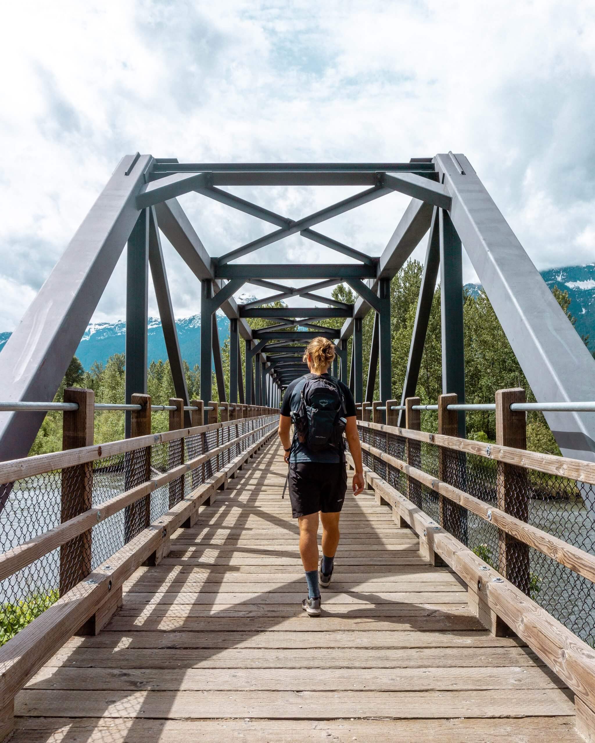 Dom walking on a bridge in Revelstoke.
