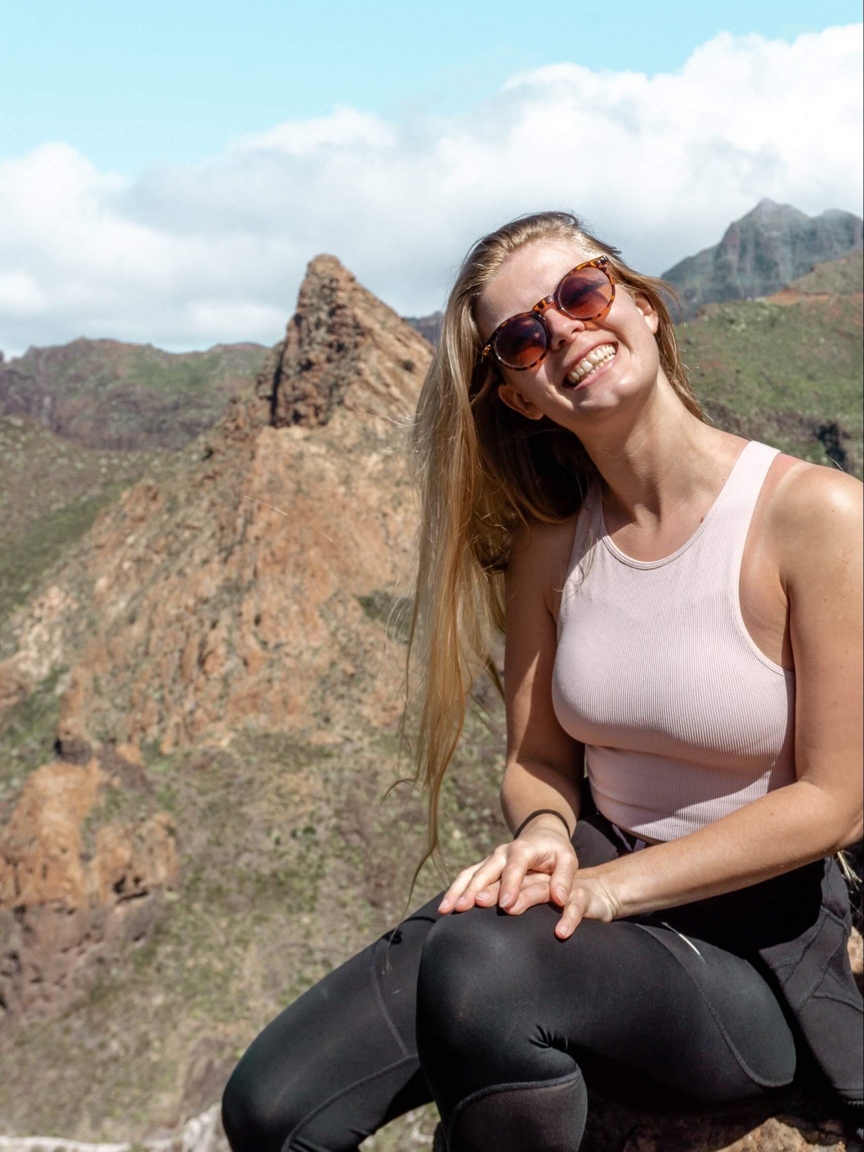 Jo smiling at the top of a hike in Tenerife.