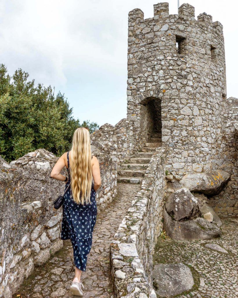 A girl walking the walls of Castle of Moors.