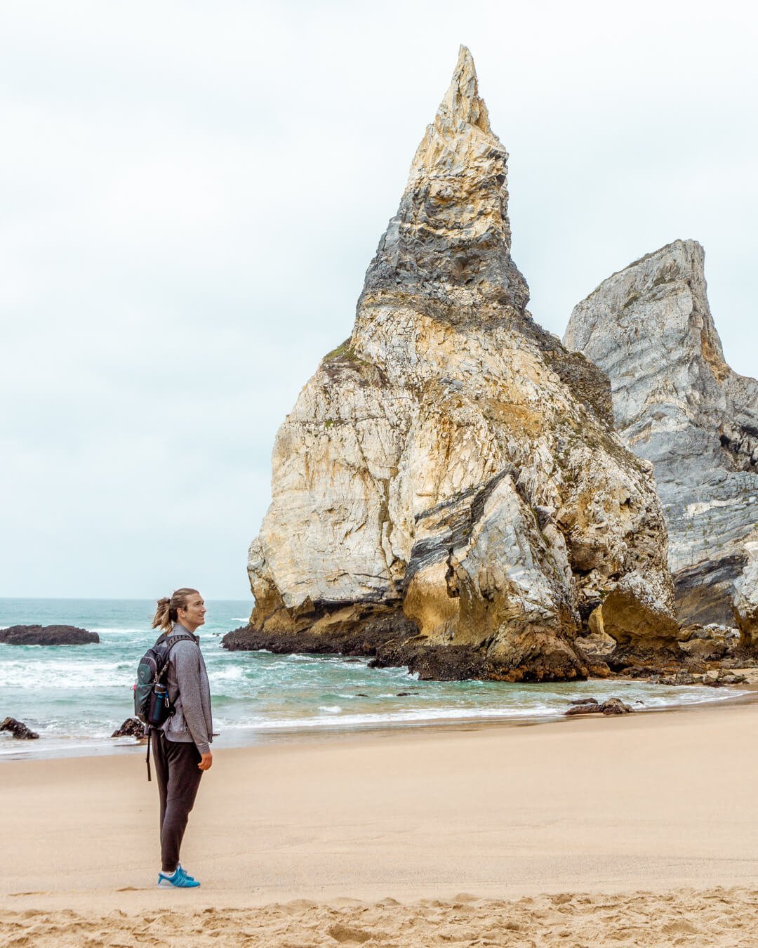 A man standing on a beach in Portugal.