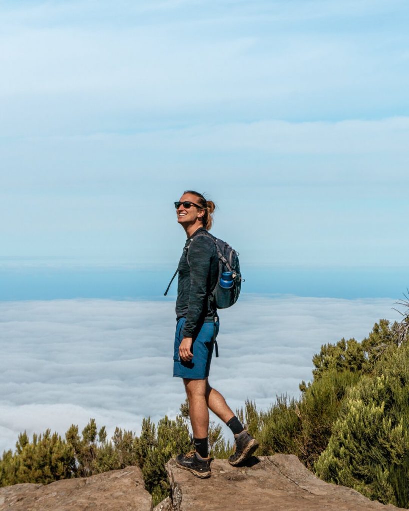 A guy posing for a picture up above the clouds in the Madeira mountains.