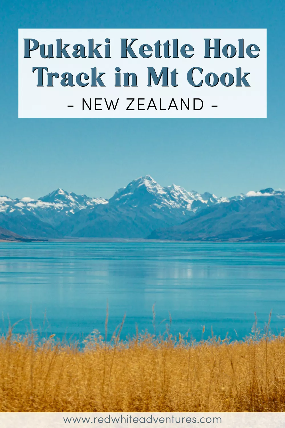A wide shot of Lake Pukaki's vivid blue water framed by dry golden grass, with Mount Cook and the Southern Alps towering in the background, and text that says "Pukaki Kettle Hole Track in Mt Cook – New Zealand".