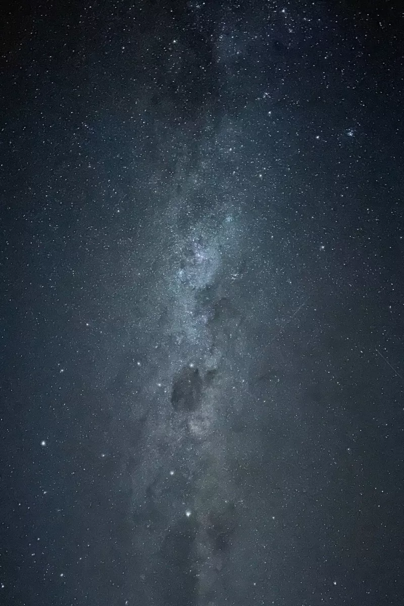 The Milky Way galaxy stretches across the night sky in a long-exposure photo taken near Tekapo in the Aoraki Mackenzie Dark Sky Reserve. Thousands of stars and the cloudy galactic core are clearly visible in this pristine stargazing location.