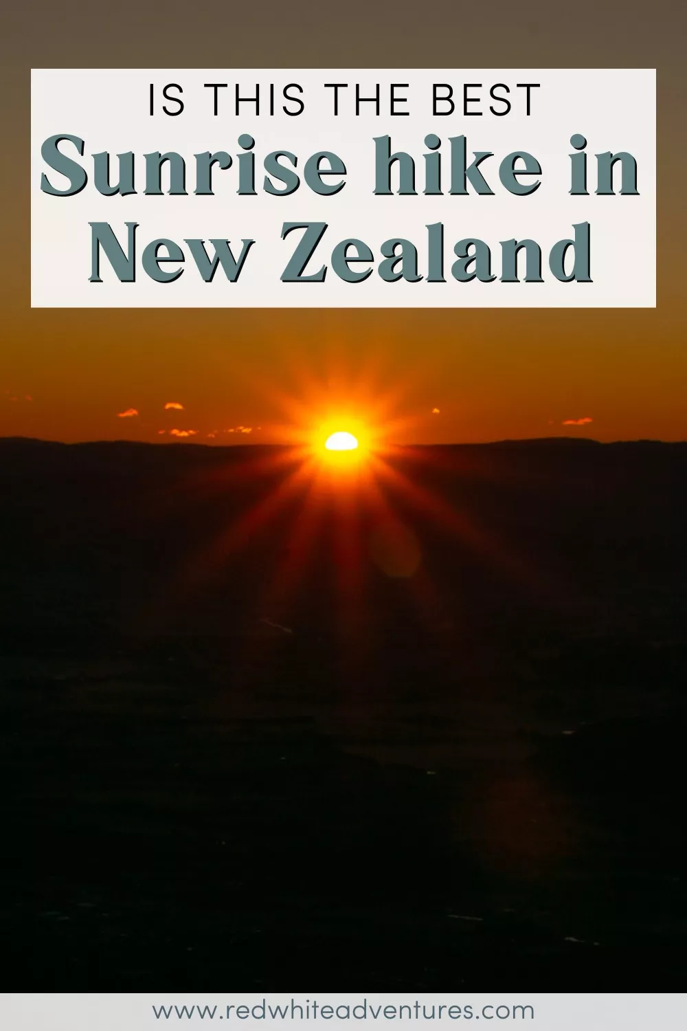 A glowing orange sun rises above dark mountain silhouettes, casting warm light across the sky. Overlay text asks, “Is this the best sunrise hike in New Zealand”.