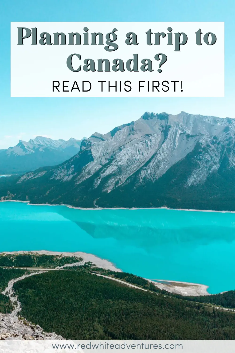 A bright turquoise lake winds through a forested valley beneath rugged grey mountains under a clear blue sky. Text overlay reads “Planning a trip to Canada? Read this first!”