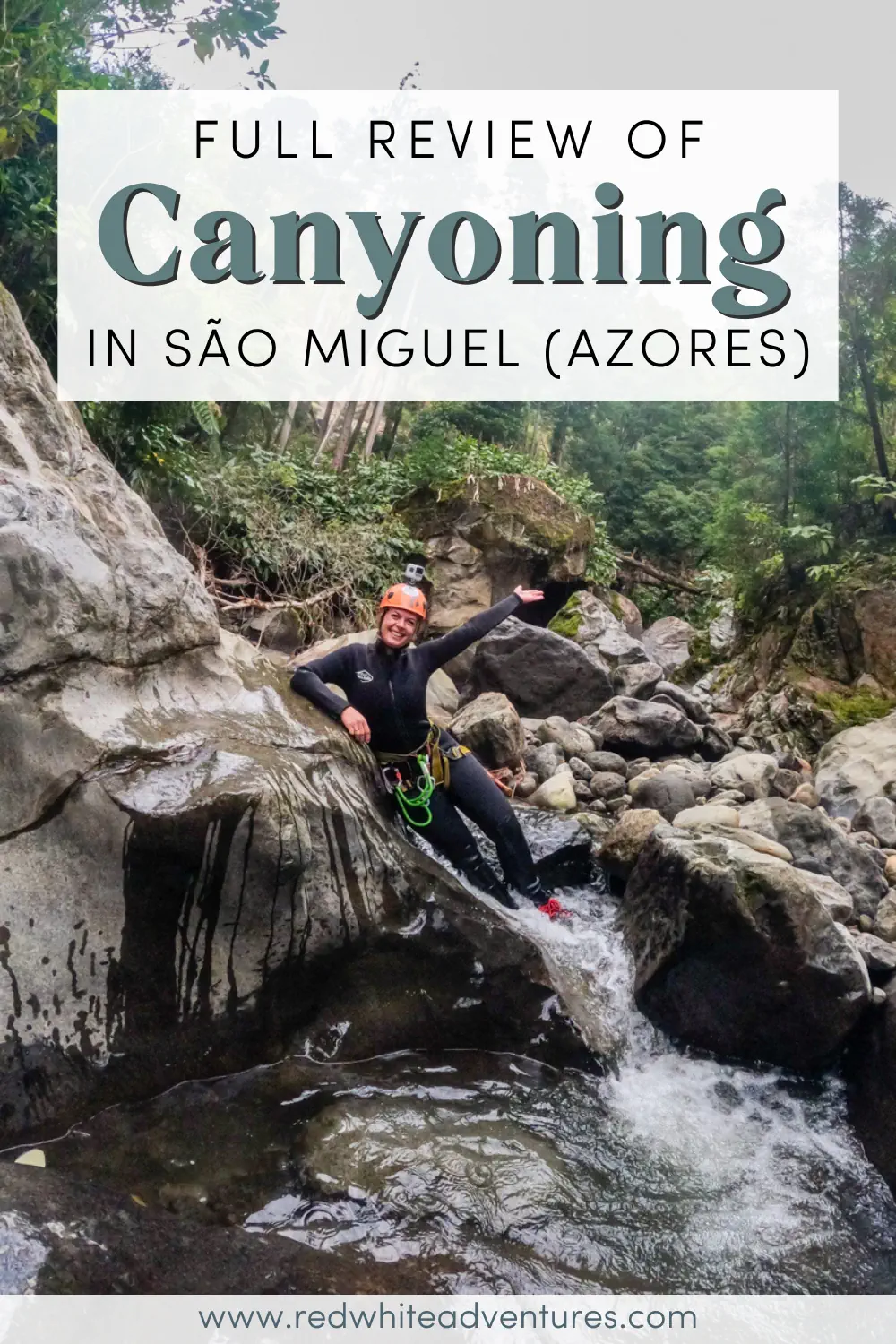 A woman in canyoning gear poses on wet rocks into a shallow stream in São Miguel, Azores. Text overlay reads “Full review of canyoning in São Miguel (Azores).”