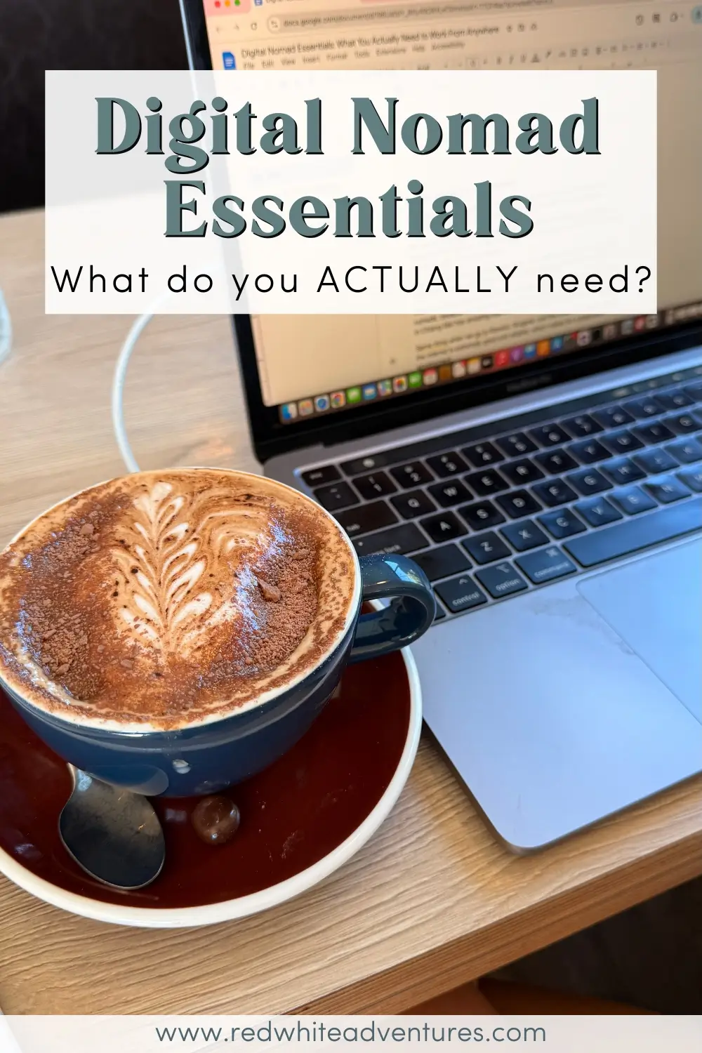 A cappuccino with latte art sits beside an open laptop on a wooden table, with text reading “Digital Nomad Essentials: What do you ACTUALLY need?” The image represents remote work and daily routines for digital nomads working from cafés.