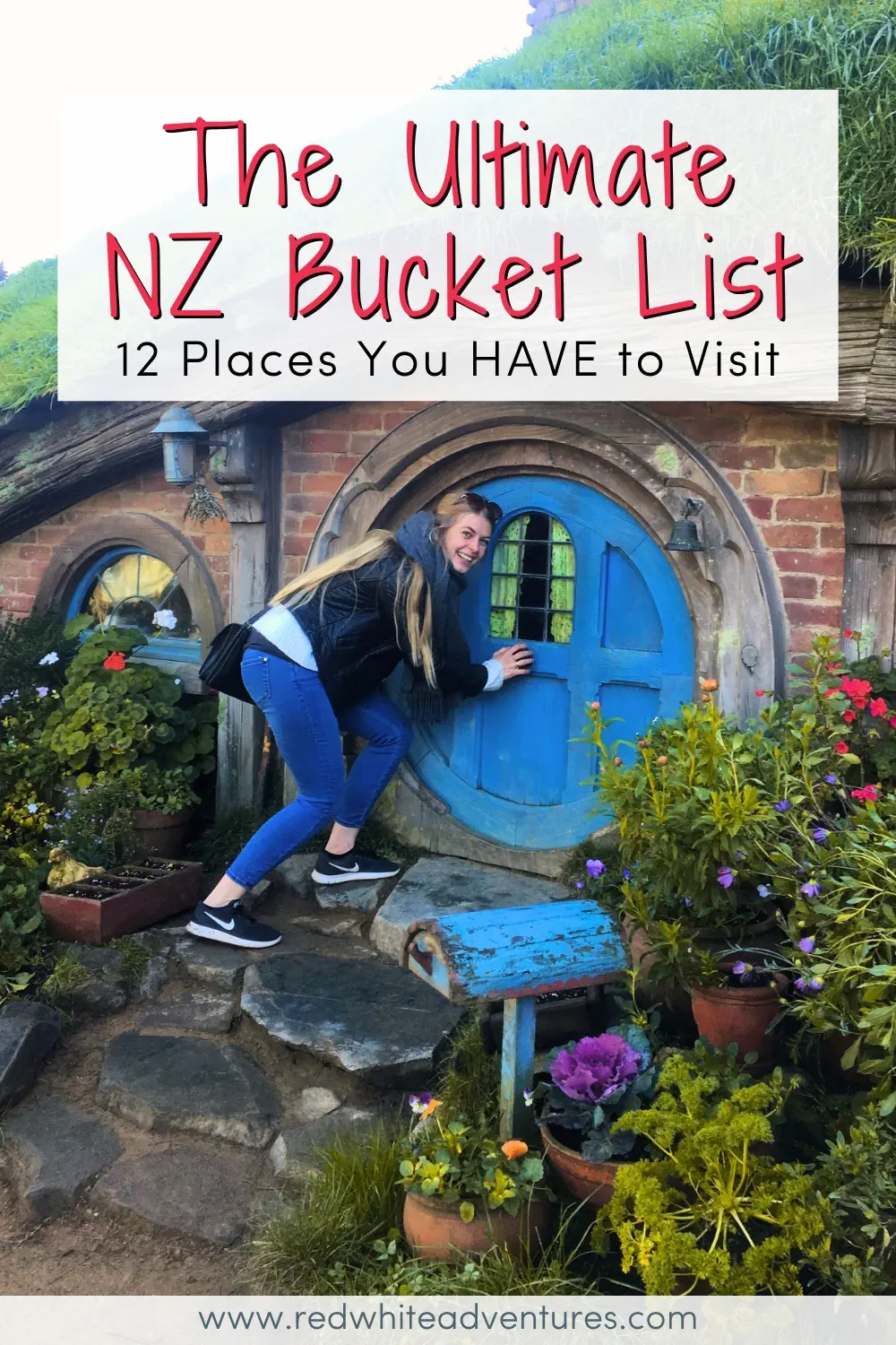 A woman leans toward a round blue door of a Hobbit style house surrounded by lush plants and flowers. Text reads The Ultimate NZ Bucket List 12 Places You HAVE to Visit.