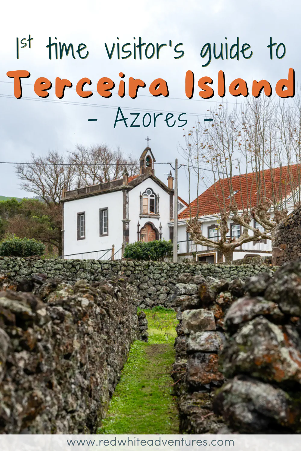 A narrow grass path runs between two lava stone walls on Terceira Island, leading toward a small white chapel with a cross and ornate wooden doorway, framed by bare trees under a cloudy sky. Text overlay reads "1st time visitor's guide to Terceira Island, Azores."