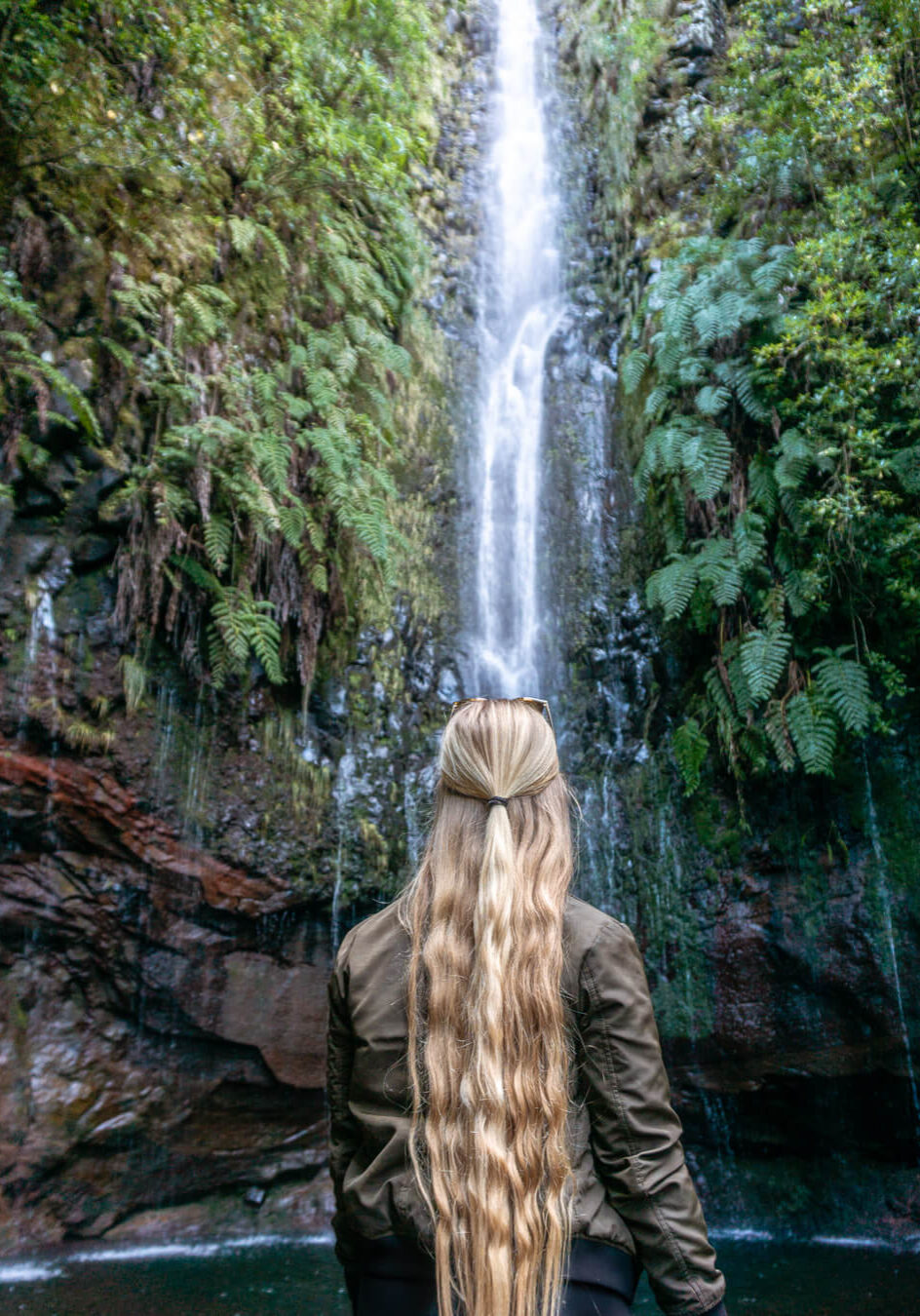 A girl standing in front of 25 Fontes in Madeira.