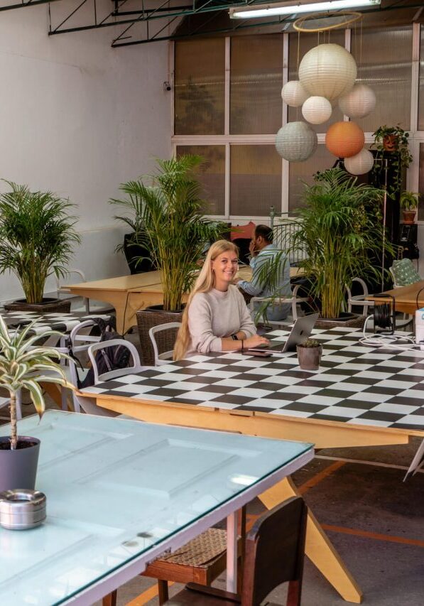 A girl working at a coworking place in Funchal.