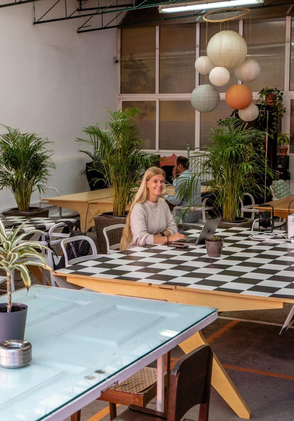 A girl working at a coworking place in Funchal.