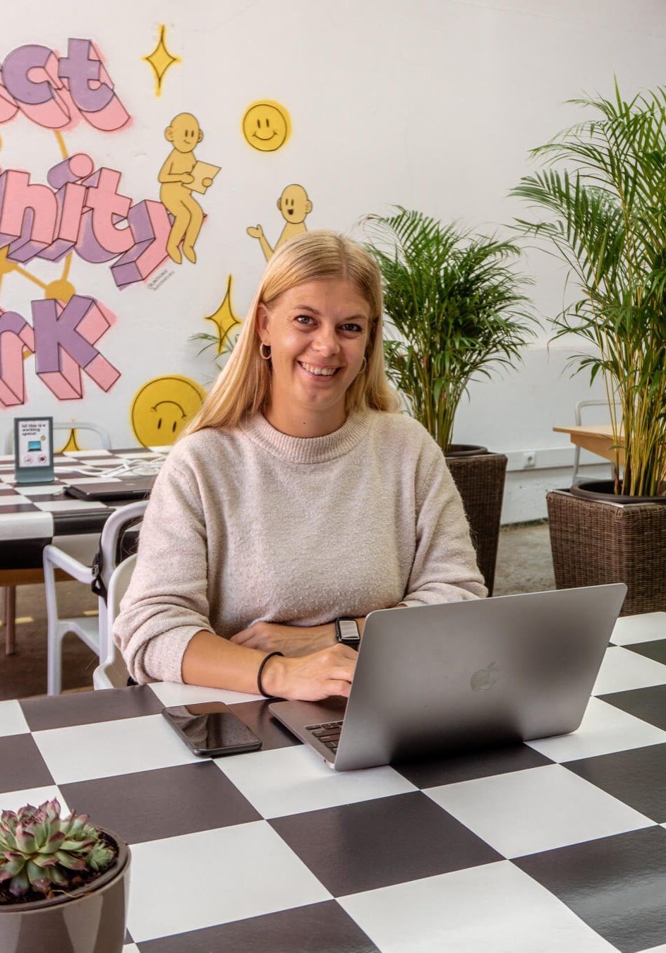A girl working in the garden space at Cowork Funchal.