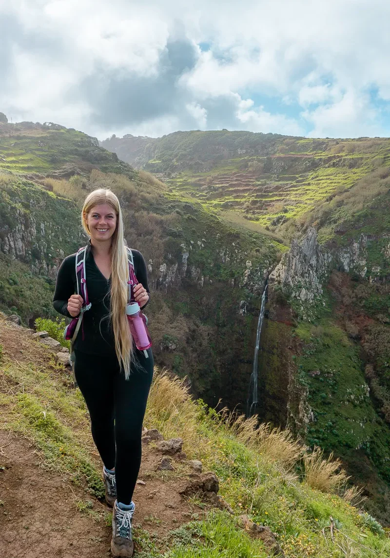 Jo standing in front of Garganta Funda Waterfall in Madeira.