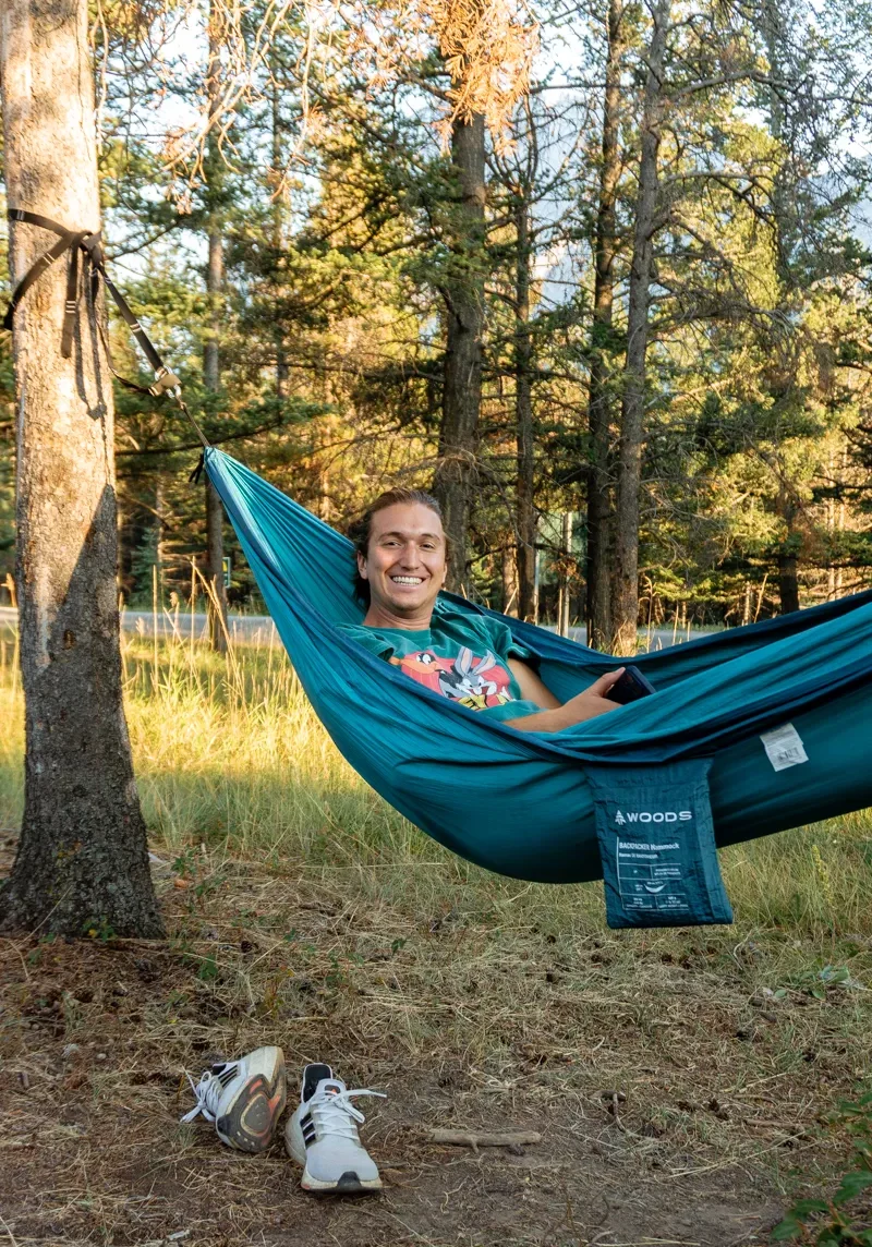 Dom relaxing in a hammock at H! Banff Alpine Centre.