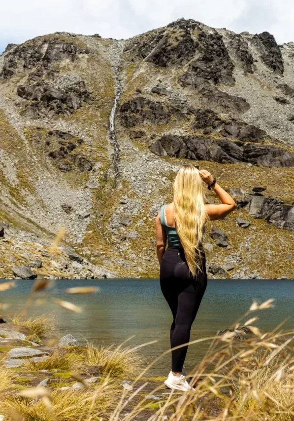 Jo taking in the view of a waterfall and Lake Alta up in the mountains near Queenstown.