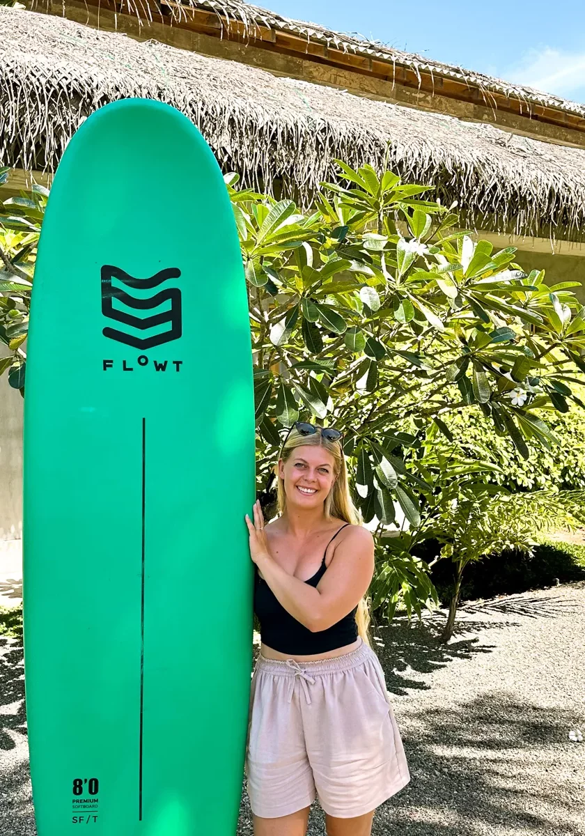 Jo standing next to her surfboard at Lapoint Surf Camp in Sri Lanka.