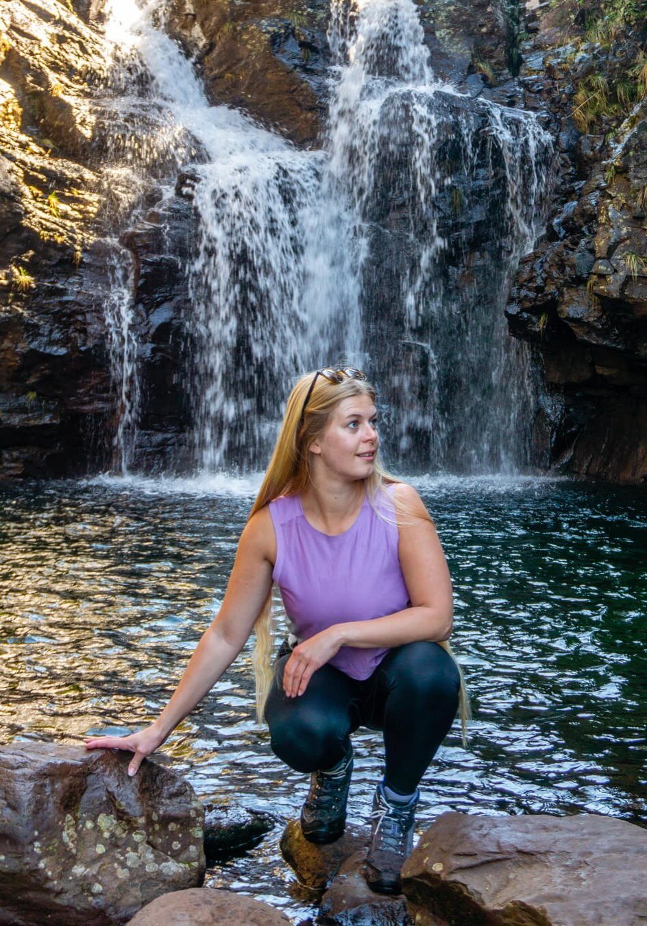 A girl posing for a picture along the Levada do Alecrim hike in Madeira.