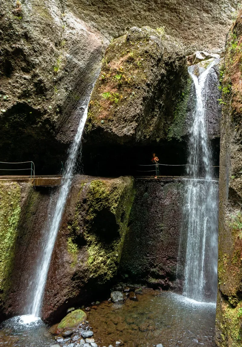 Jo standing under the Nova Moinho Waterfall in Madeira.