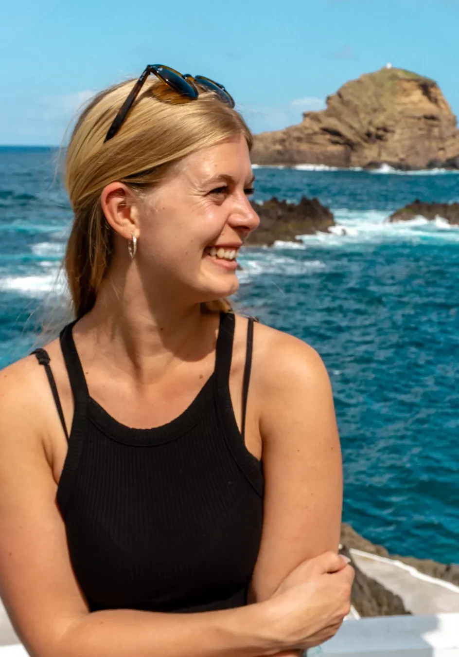 Jo smiling while she enjoys the coat in Porto Moniz.
