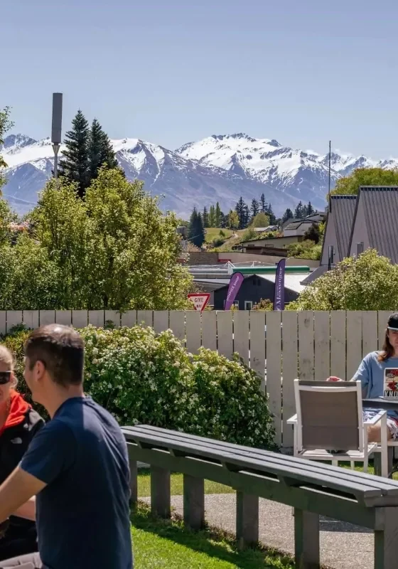 People enjoying a sunny day at the Mountain View Backpackers in Wanaka.