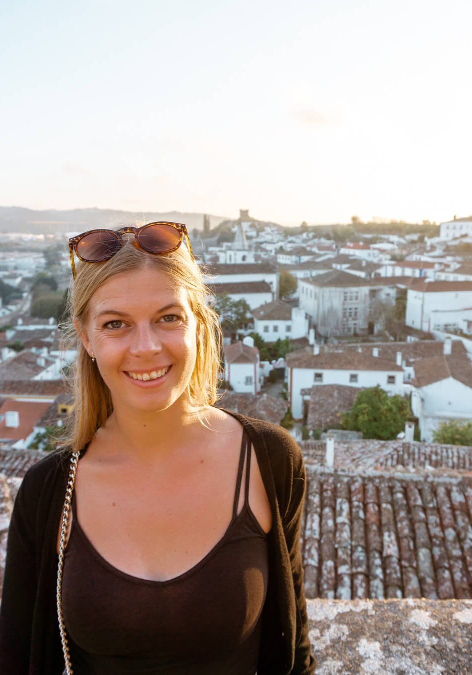 A girl overlooking the buildings in Obidos Castle