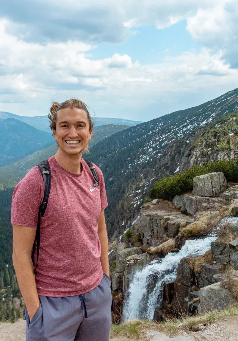 Dom smiling once he's made it to the top of Pancavsky Vodopad.