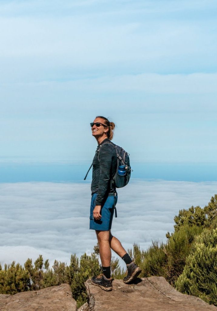 A guy posing for a picture up above the clouds in the Madeira mountains.