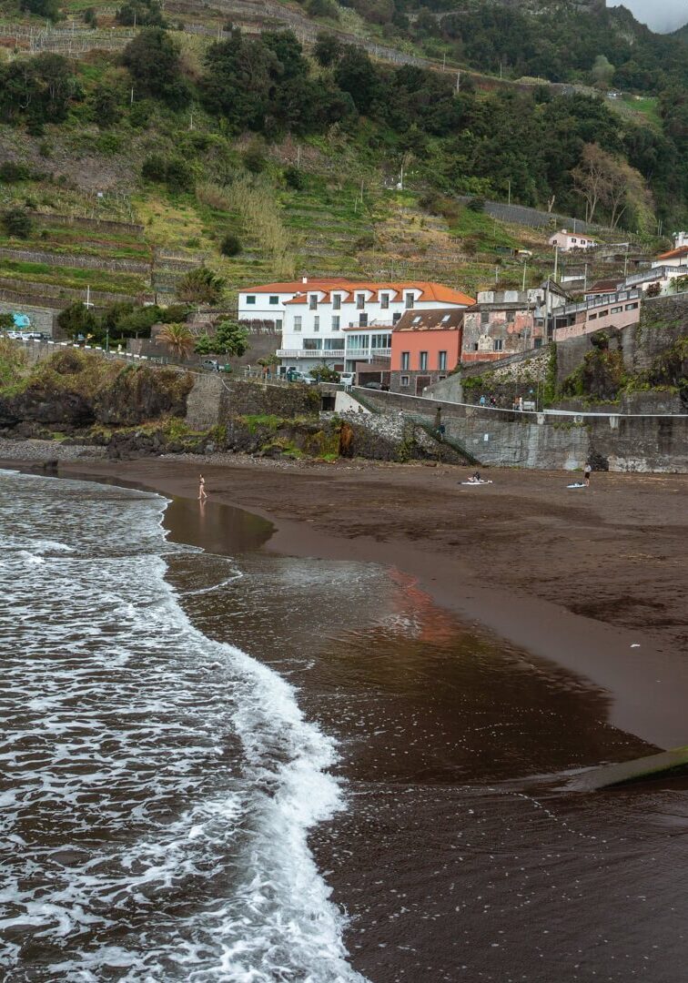 Quiet photo of the black sand Praia de Seixal Beach.