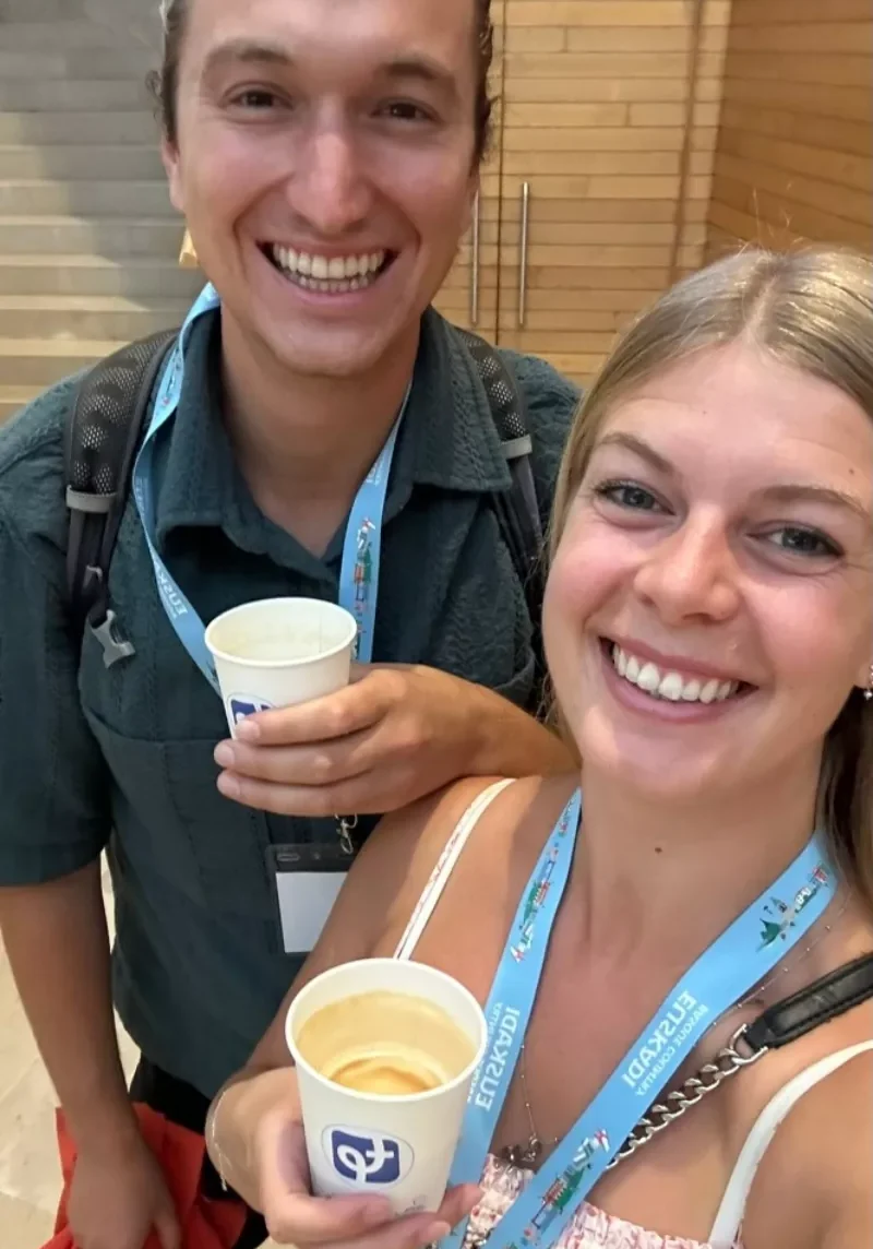 Couple drinking coffee at a travel conference.