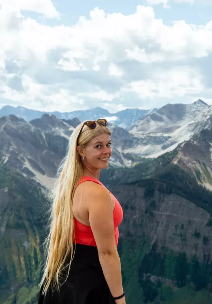 Jo posing for a picture at the top of Kicking Horse Mountain Resort.