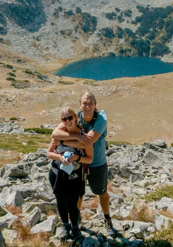 SafetyWing sponsor photo of Dom and Jo hiking up a mountain in the Pirin National Park.