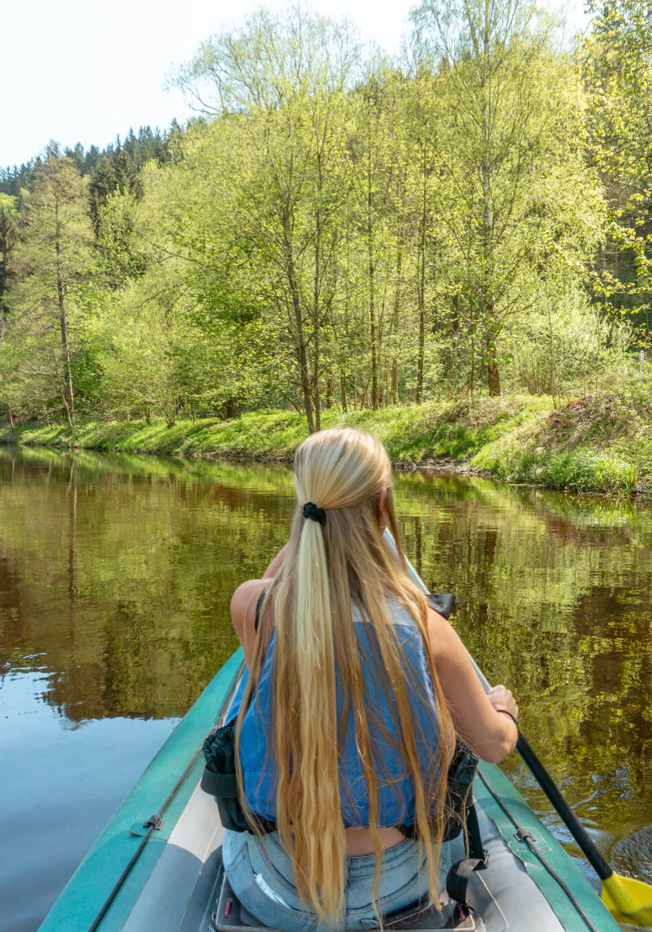 A girl canoeing on the Vltava River near Cesky Krumlov in the Czech Republic.