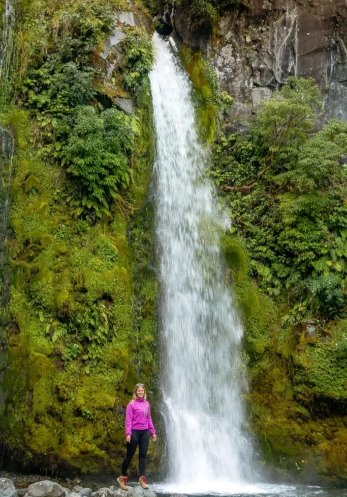 Jo standing next to the famous Dawson Falls waterfall near Taranaki.