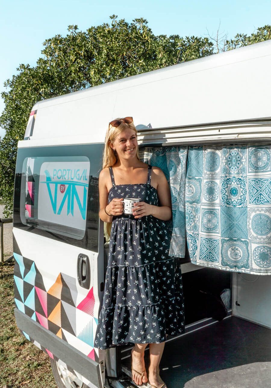 A lady standing next to her van outside in Portugal.