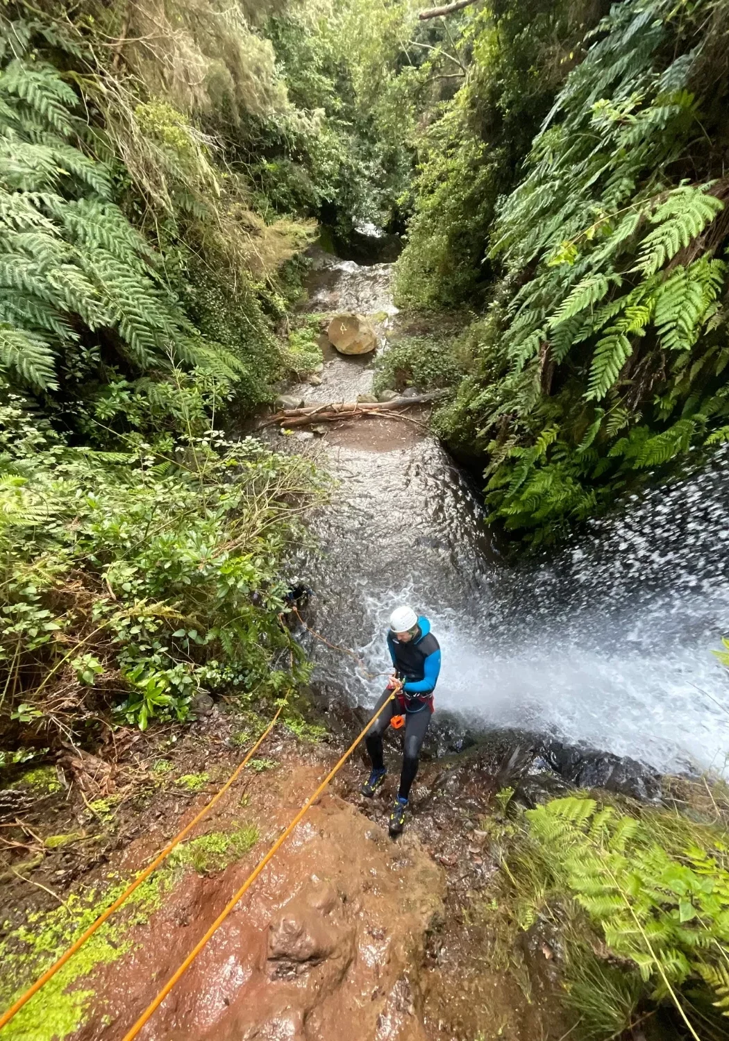 Dom rappelling down a waterfall during his canyoning tour in Madeira.