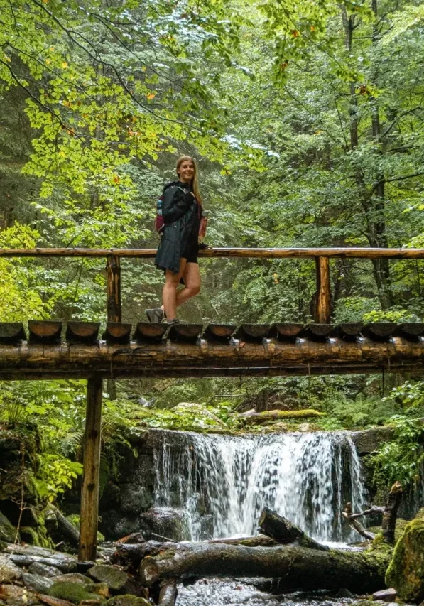 Jo hiking along a bridge that crosses the Bila Opava River.