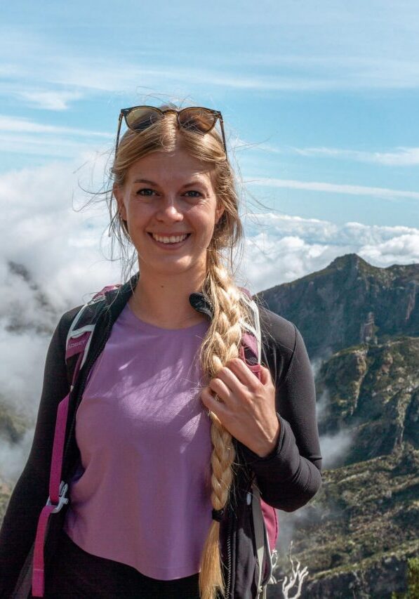 Girl standing at the top of Pico do Arieiro hike in Madeira.